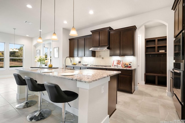 kitchen with stainless steel appliances, recessed lighting, decorative backsplash, and a sink