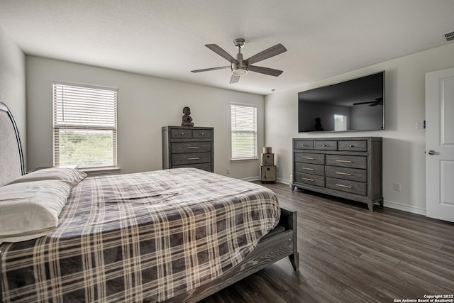 bedroom featuring baseboards, a ceiling fan, and dark wood finished floors