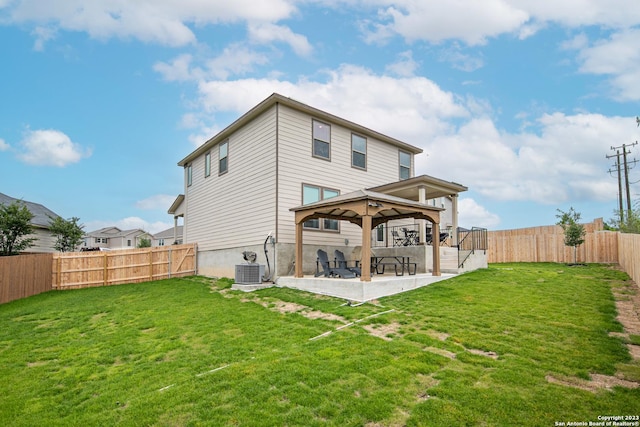 back of property featuring a fenced backyard, a patio, a gazebo, and a lawn