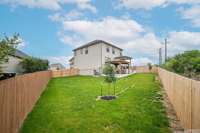 view of yard with a gazebo, central AC unit, and a fenced backyard
