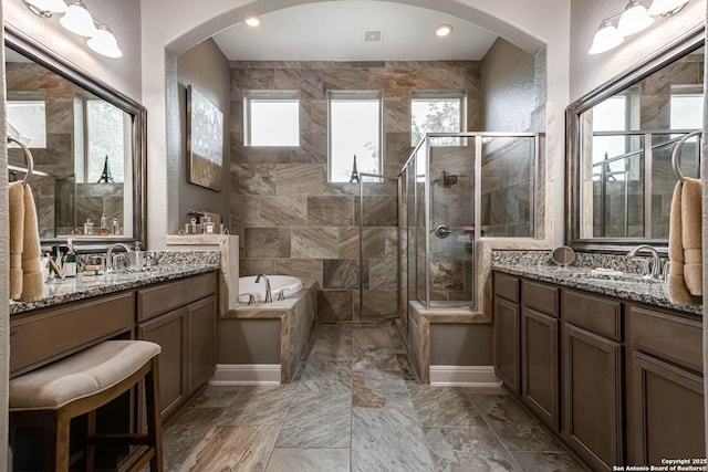 full bath with a garden tub, a sink, baseboards, and a shower stall