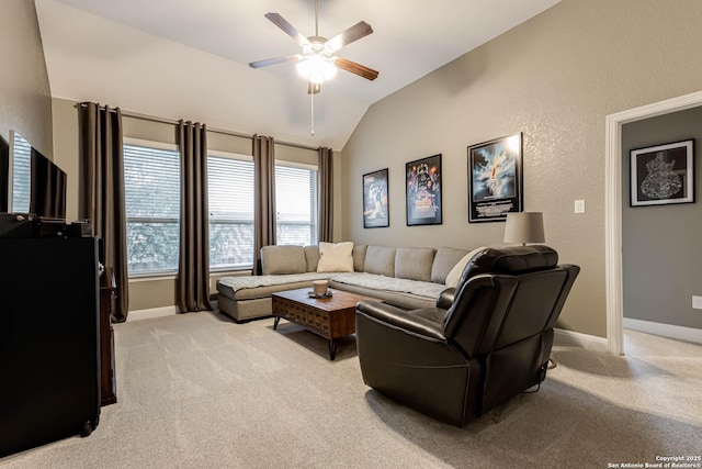 living room with baseboards, ceiling fan, lofted ceiling, and light carpet