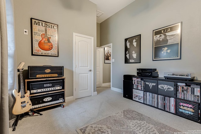 sitting room featuring baseboards and carpet