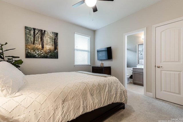 bedroom featuring light colored carpet, connected bathroom, and ceiling fan