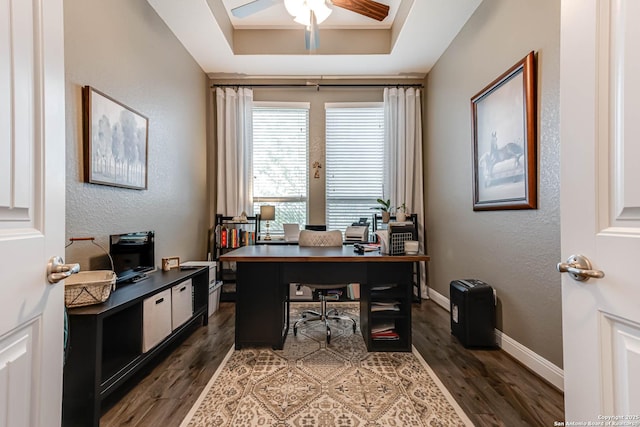 home office with dark wood-type flooring, baseboards, ceiling fan, and a textured wall
