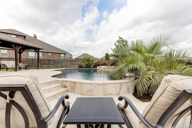 view of pool featuring fence, a fenced in pool, and a patio area