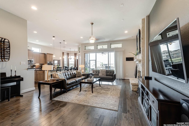 living area featuring recessed lighting, a ceiling fan, and dark wood-style floors