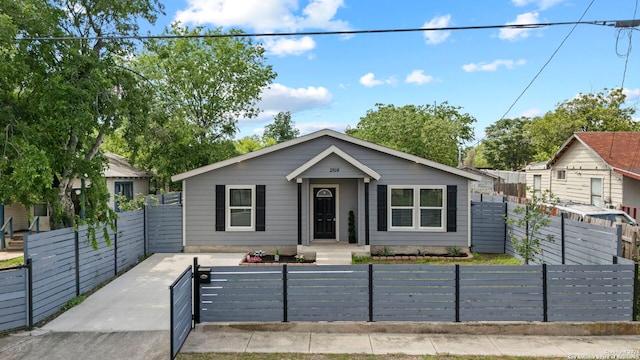 bungalow-style home featuring a fenced front yard and a gate