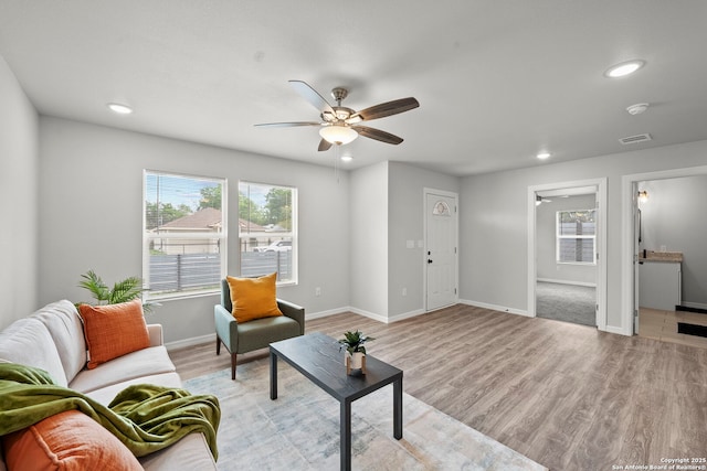 living area featuring a ceiling fan, recessed lighting, light wood-style flooring, and visible vents