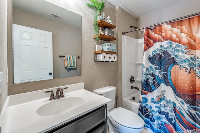bathroom featuring a textured wall, vanity, toilet, a textured ceiling, and visible vents
