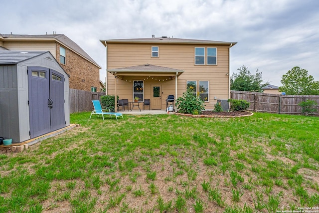 rear view of property with a fenced backyard, a patio area, a shed, and a yard