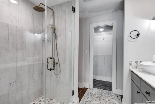 700 Dawson, San Antonio, TX 78202 - bathroom featuring vanity, a shower stall, wood finished floors, and a spacious closet