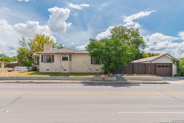 700 Dawson, San Antonio, TX 78202 - ranch-style home with a chimney, a garage, fence, concrete driveway, and stone siding