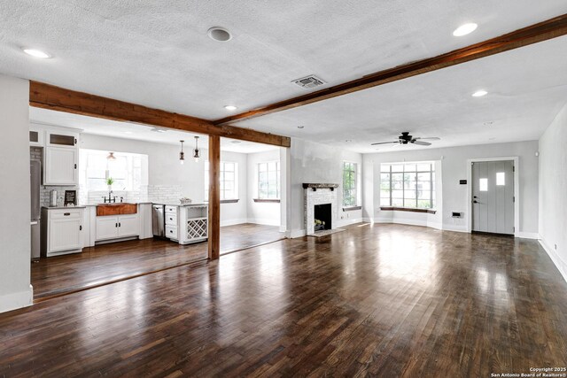 700 Dawson, San Antonio, TX 78202 - unfurnished living room featuring visible vents, a fireplace, baseboards, ceiling fan, and dark wood finished floors