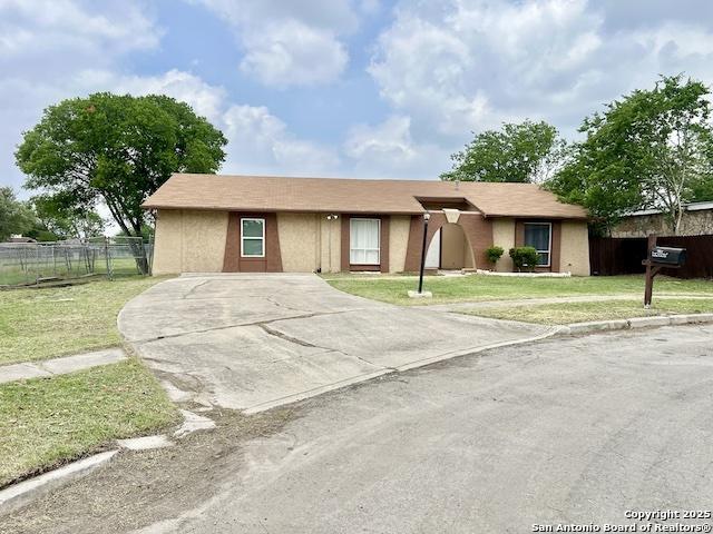 6803 Indian Lk, San Antonio, TX 78244 - ranch-style house with stucco siding, a front lawn, fence, and concrete driveway