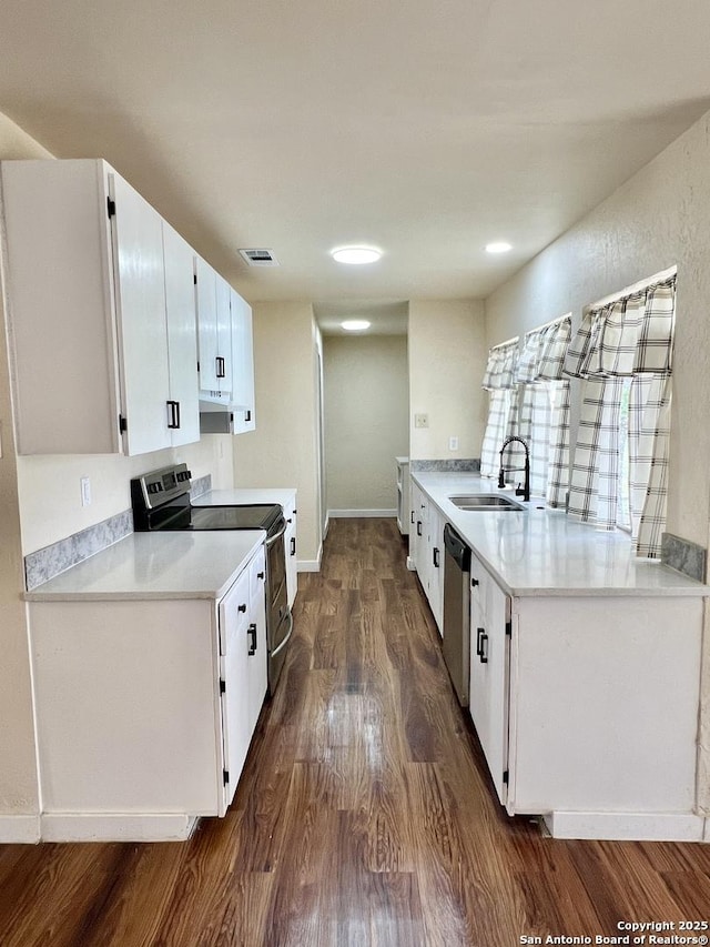 6803 Indian Lk, San Antonio, TX 78244 - kitchen with dark wood-style flooring, visible vents, appliances with stainless steel finishes, a sink, and white cabinetry