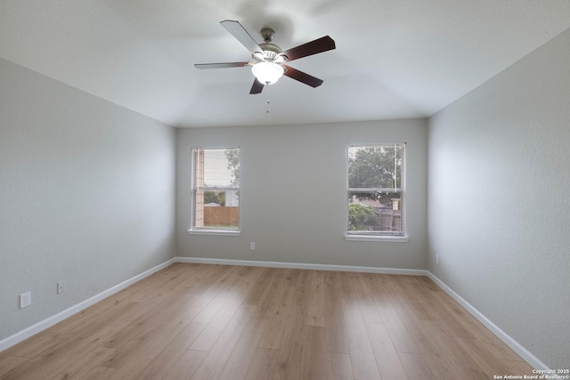 unfurnished room featuring light wood-type flooring, baseboards, ceiling fan, and a wealth of natural light