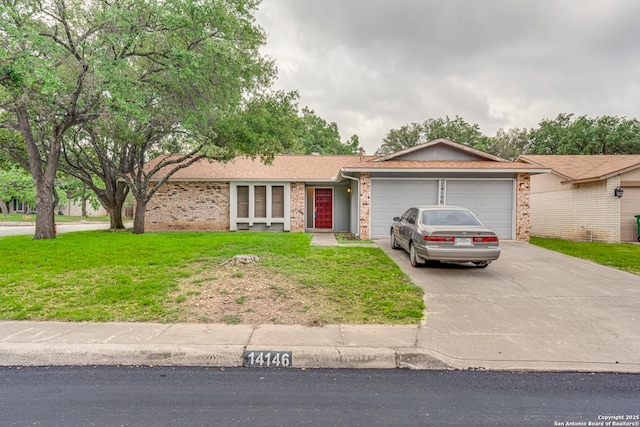 ranch-style house with brick siding, a garage, a front yard, and concrete driveway