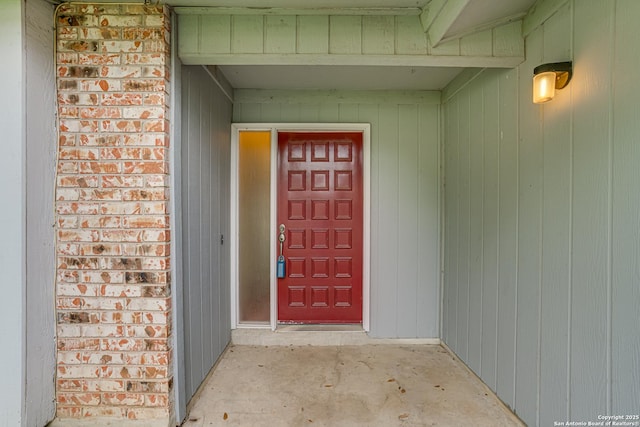 view of exterior entry with brick siding