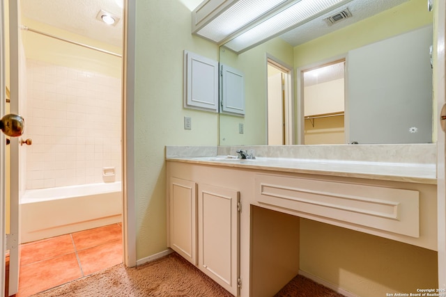 bathroom featuring visible vents, vanity, baseboards, shower / bathing tub combination, and tile patterned floors