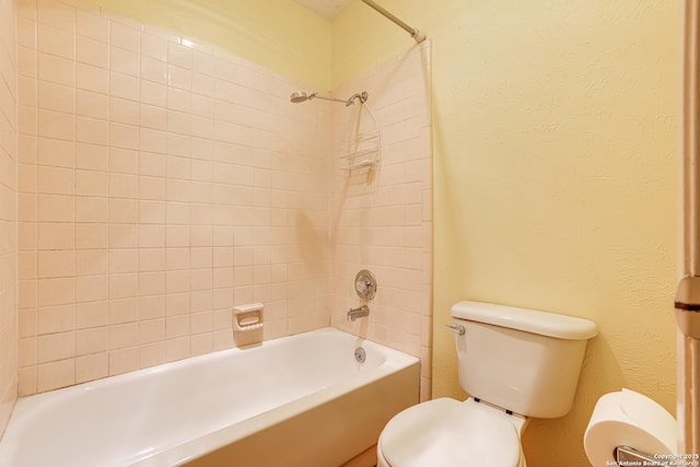 full bathroom with toilet, a textured wall, and bathtub / shower combination