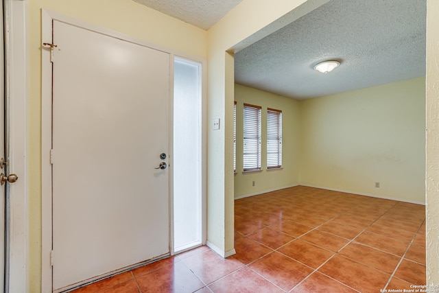 entrance foyer featuring tile patterned flooring and a textured ceiling