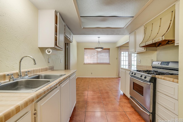 kitchen featuring stainless steel range with gas stovetop, a sink, and light countertops
