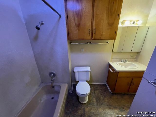 full bathroom featuring vanity, tub / shower combination, and toilet