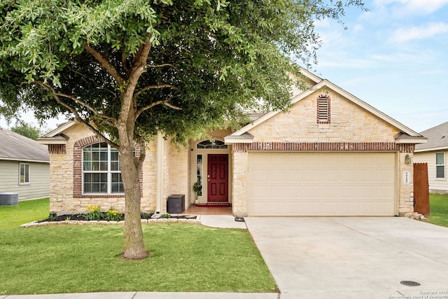 view of front facade with an attached garage, a front yard, driveway, and stone siding