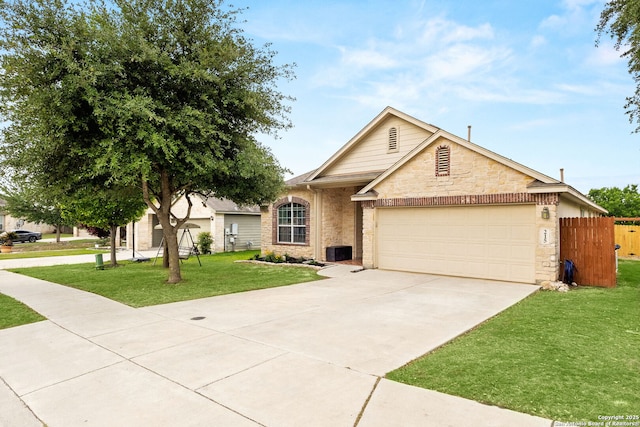 ranch-style house featuring fence, an attached garage, stone siding, a front yard, and driveway