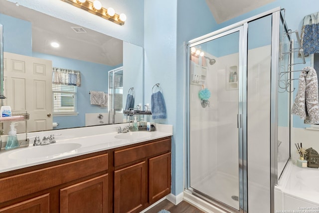 bathroom with double vanity, visible vents, a sink, and a stall shower