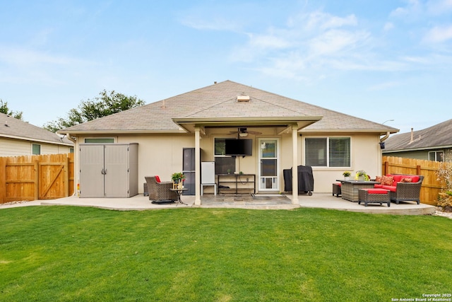 rear view of house with fence, stucco siding, an outdoor living space, a patio area, and a ceiling fan