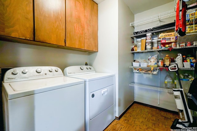 laundry room with washer and clothes dryer and cabinet space