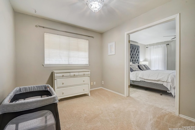 bedroom featuring baseboards and light carpet