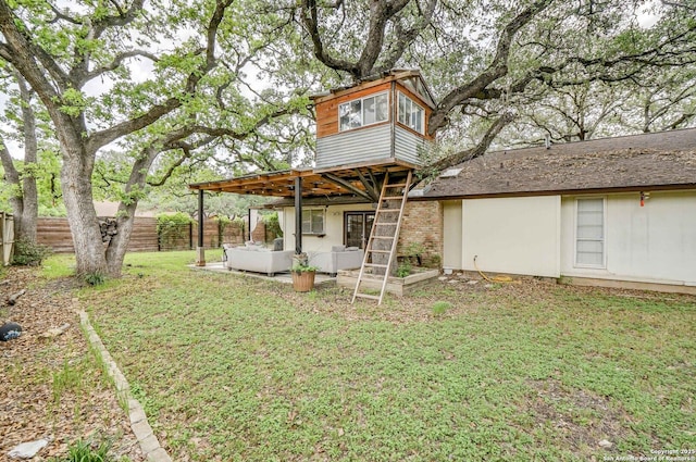 back of property with an outdoor hangout area, a lawn, a fenced backyard, and a patio area
