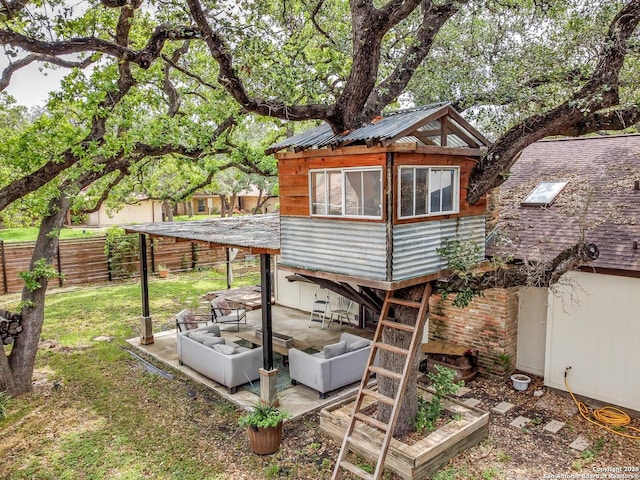 rear view of property with a lawn, a patio, and fence