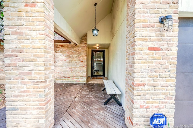 entrance to property featuring brick siding