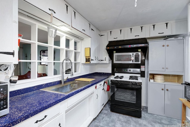 kitchen featuring stainless steel microwave, range with gas stovetop, a sink, and open shelves