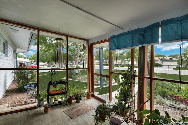 unfurnished sunroom with wood finished floors