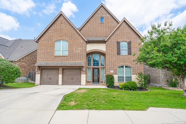 view of front facade featuring a garage, concrete driveway, a front yard, and brick siding