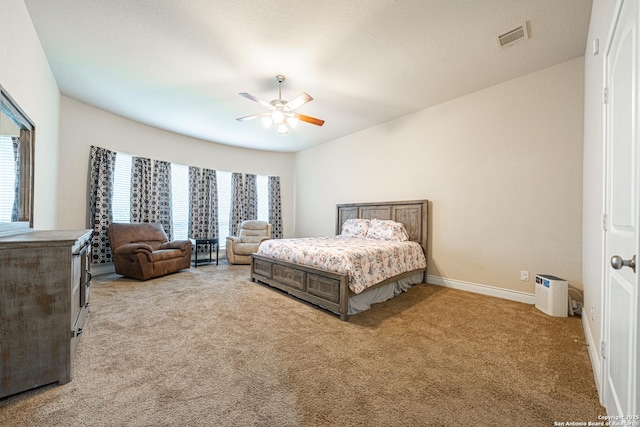 bedroom with carpet floors, baseboards, ceiling fan, and visible vents