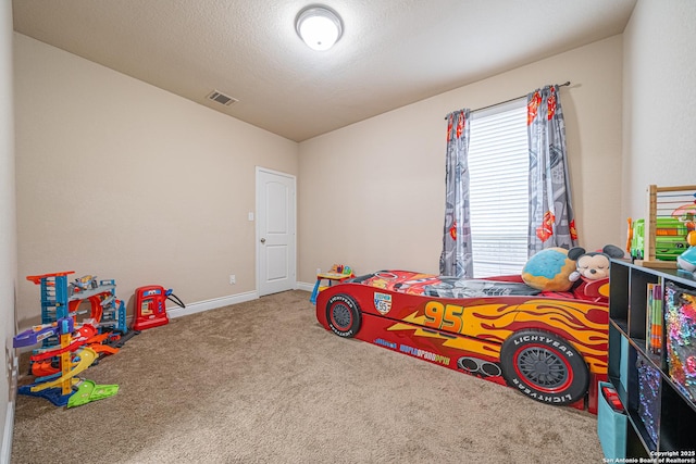 carpeted bedroom featuring baseboards and visible vents