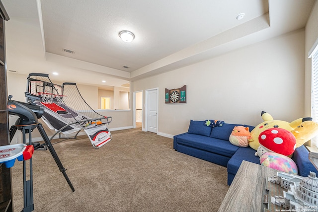 game room featuring a tray ceiling, baseboards, carpet flooring, and visible vents