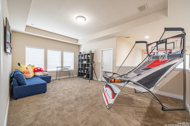 playroom with a textured ceiling, visible vents, a raised ceiling, baseboards, and carpet