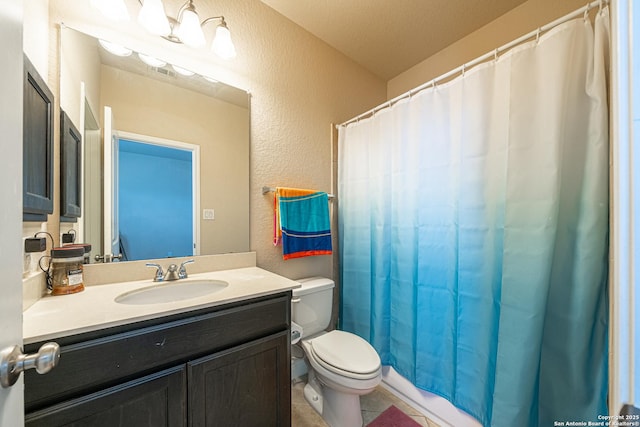 bathroom featuring a textured wall, tile patterned flooring, vanity, toilet, and visible vents