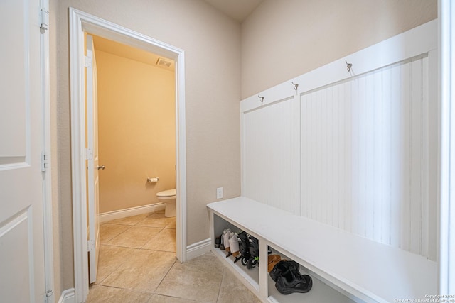 mudroom featuring light tile patterned floors, baseboards, and visible vents