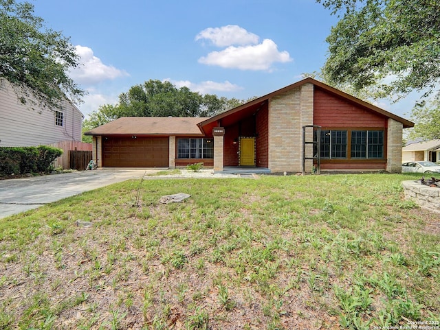 view of front facade with a garage, fence, driveway, and a front yard