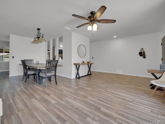 dining room with baseboards, a ceiling fan, light wood-style flooring, and recessed lighting