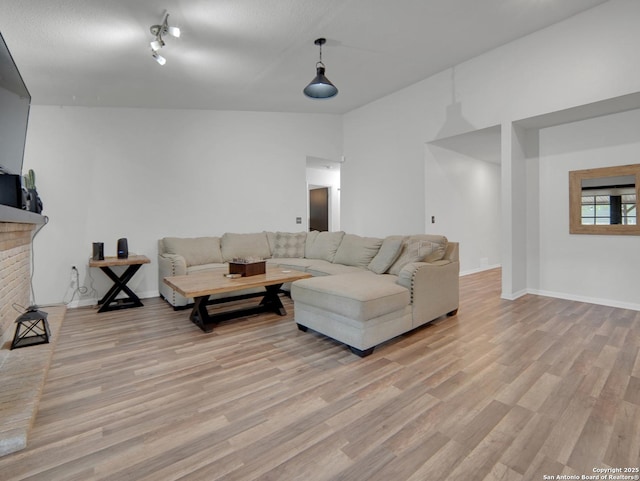 living area with baseboards and light wood-style flooring