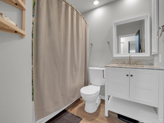 bathroom featuring vanity, a shower with curtain, toilet, and wood finished floors